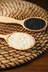 Black and white sesame seeds on wicker mat