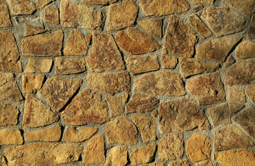 Texture of concrete wall decorated with stones as background, closeup