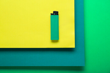 Stylish small pocket lighter on color background, top view
