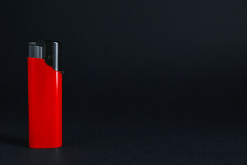 Stylish small pocket lighter on black background, space for text