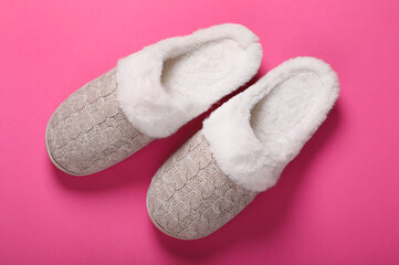 Pair of beautiful soft slippers on pink background, top view