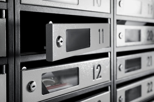 Open empty mailbox with keyhole and number, closeup