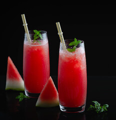 Refreshing summer watermelon juice in glasses with slices of watermelon
