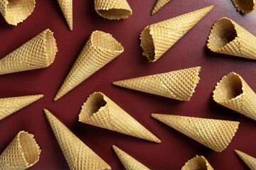 Ice cream cones pattern. Brown background. Sweet, summer and empty concept. Top view. Flat lay