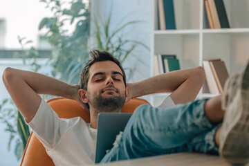 young man at home sleeping relaxed with computer