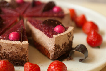 chocolate cake with strawberries close up. slice with chocolate drips and souffle. Confectionery