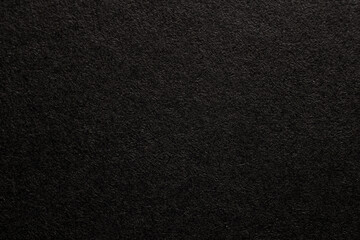 Black paper texture background. Black blank page. Background for your text. Macro photo.