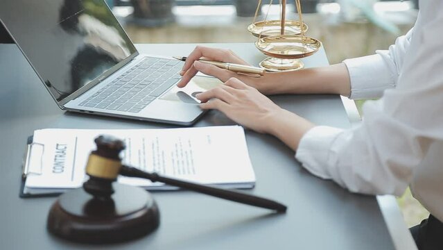 Business and lawyers discussing contract papers with brass scale on desk in office. Law, legal services, advice, justice and law concept picture with film grain effect
