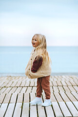 Child girl happy smiling walking outdoor kid wearing fluffy sherpa jacket fashion outfit 4 years...