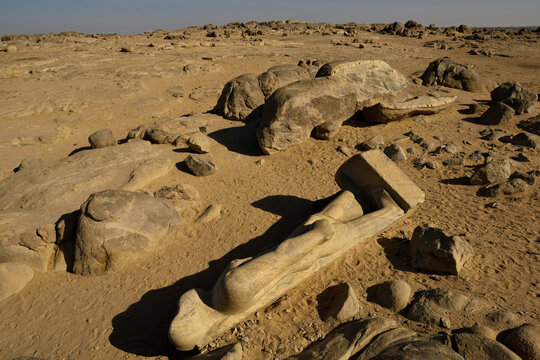 At Tumbus, a broken statue of king Taharqa from the Kustite period lies by the main road that follows the east bank of the Nile.; Kerma, Sudan, Egypt.