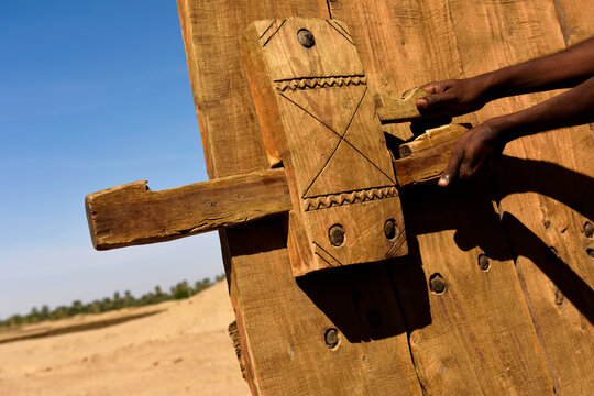 A wooden door lock on the mud-brick deffufa.; Sudan, Africa.