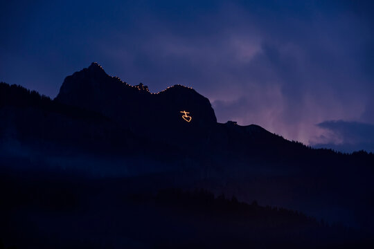 To celebrate the Herz-Jesu, Sacred Heart, festival, the people of the Tannheaim region in Austria climb up the neighbouring mountains and at twilight light fires in religious shapes to acknowledge and