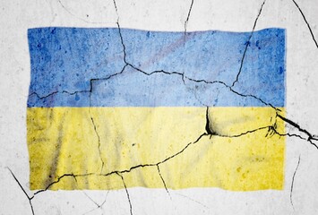 An image of the flag of Ukraine on a wall with a crack. A crisis.