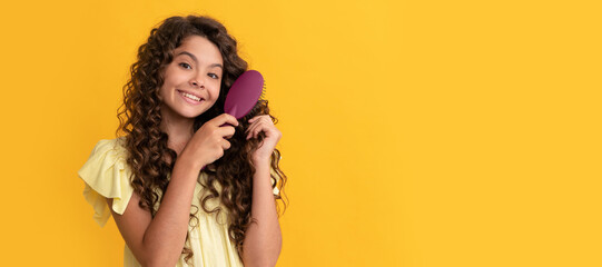 hairdresser. kid smile with curly hair hold hairbrush. teen beauty hairstyle. Kid girl hair care, horizontal poster. Banner header with copy space.