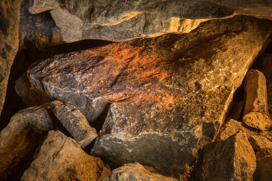 Hoard of ocher stored by ancient artists between collapsed blocks in Hall of Chaos in Shulgan-Tash (Kapova) cave. This ocher was used for drawing on cave walls, Ural Mountains; Russia