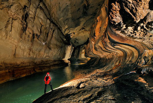 A Mulu Cave Project expedition member progresses downstream in Clearwater River Cave.