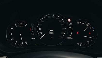 Fototapeta premium Close up shot with the digital car dashboard. Illuminated car dashboard.