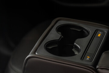 Seat heater button on the armrest, car interior.