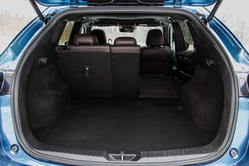 Huge, clean and empty car trunk in interior of compact suv. Rear view of a SUV car with open trunk