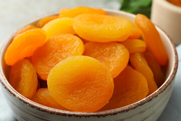 Bowl of tasty apricots on table, closeup. Dried fruits