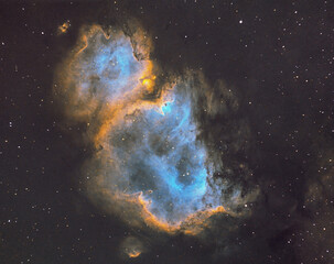 astro photo for full view of soul nebula in hubble palette with space dust and colorful stars	