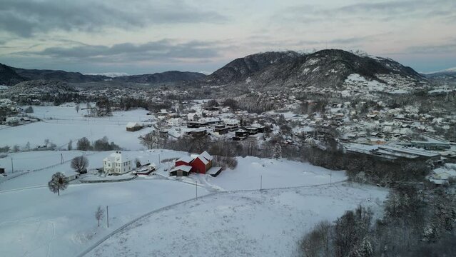 Sunset over Norwegian coastal landscape. Winter, mountains and fjord.