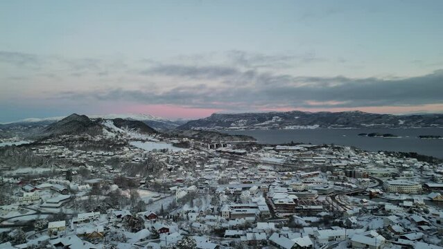 Sunset over Norwegian coastal landscape. Winter, mountains and fjord.