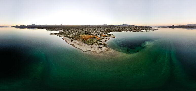 wide angle view from aerial view drone shot of lake mohave in the national recreation area of lake mead in nevada and arizona with the sun setting showing six mile cove and its sand