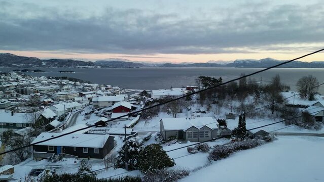 Sunset over Norwegian coastal landscape. Winter, mountains and fjord.