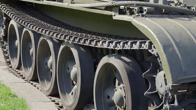 Caterpillar And Rollers Of A Green Battle Tank. Military Army Concept. Close-up Camera Movements. Caterpillar Wheels. Tank Up Close.