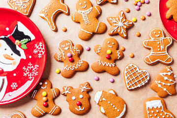 Fototapeta na wymiar Various selection of Gingerbread cookies with sugar icing. Decorated in Christmas spirit. Happy New Year celebration. Playful and fun. 