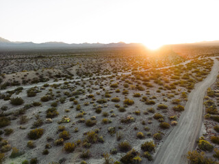 horizontal view of sand and desert with mountains and sunset from aerial view drone shot of lake mohave in the national recreation area of lake mead in nevada and arizona