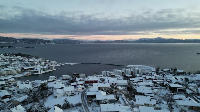 Sunset over Norwegian coastal landscape. Winter, mountains and fjord.