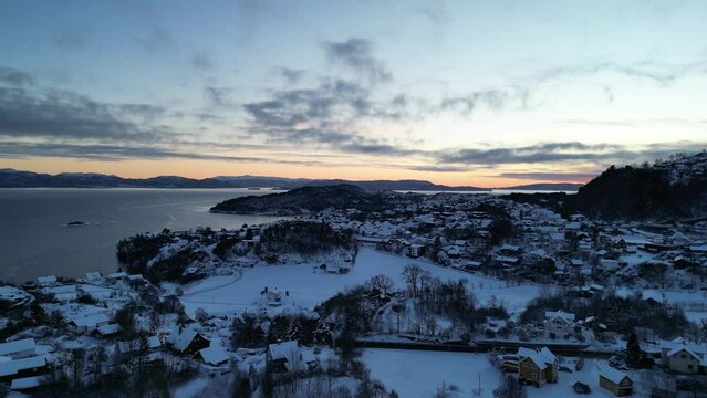 Sunset over Norwegian coastal landscape. Winter, mountains and fjord.