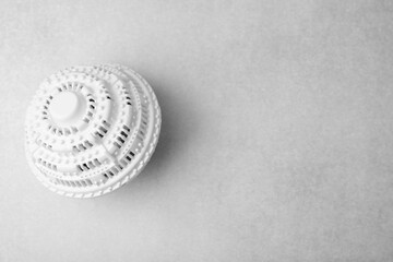 Laundry dryer ball on light grey table, top view. Space for text