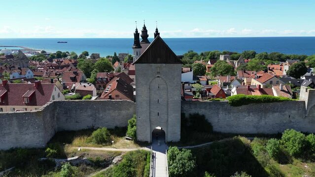 Aerial drone footage flying over the town on the Swedish island Gotland, Visby located in the Baltic Sea. Fortified wall in the Gotland island. Ancient medieval city walls, medieval Sweden city. 