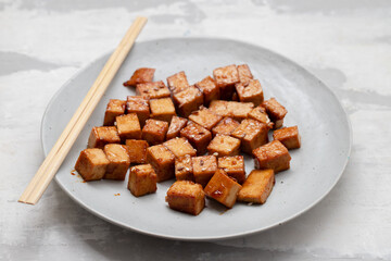 crispy deep stir fried tofu cubes on small dish