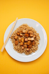 fried noodles with tofu on white dish