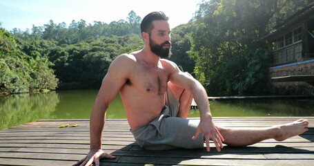 Man practicing Yoga outdoors. Person exercising physique