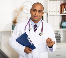 Doctor is standing with documents in clinic