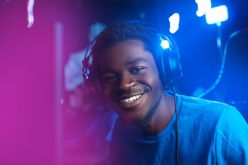 Happy Gamer African man with headphones, American player online video games in computer club esport...