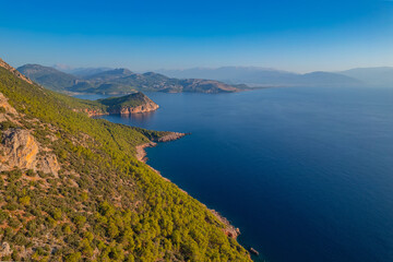 Lycian Way from forest and sea in Antalya, Turkey Aerial top view. Concept beautiful summer landscape at sunset from drone