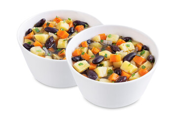 Kidney beans potato carrot vegan soup in a bowl on a white isolated background