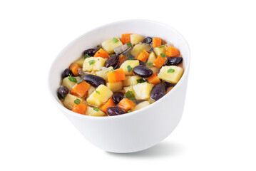 Kidney beans potato carrot vegan soup in a bowl on a white isolated background