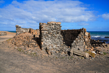 Abandoned ruins of the lime kilns of La Hondura, north of the capital city of Puerto del Rosario on Fuerteventura island in the Canaries, Spain - Crumbling ancient industrial building by the coast