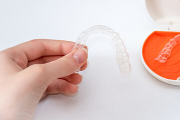 Transparent aligners retainers in a storage case. Invisible braces. Clear teeth straighteners....