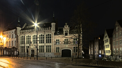 Fototapeta na wymiar Illuminated medieval building of the old fish market in the city of Ghent Flanders Belgium