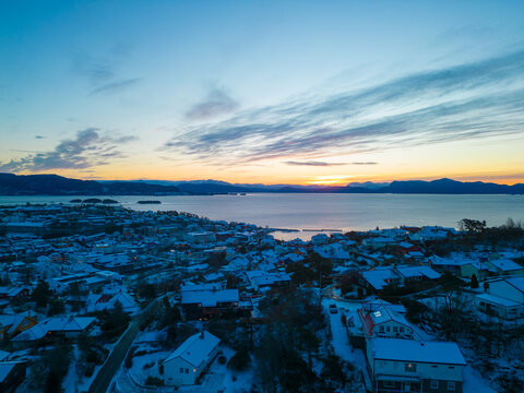 Sunset over the snow covered town center of Os&oslash;yro, Bj&oslash;rnafjorden, Norway