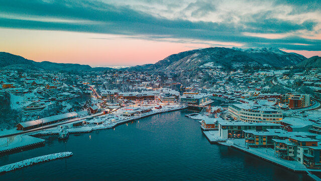 Sunset over the snow covered town center of Os&oslash;yro, Bj&oslash;rnafjorden, Norway