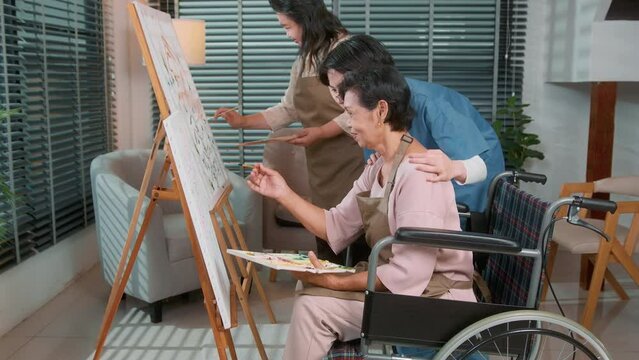Group of Asian senior people are enjoy  painting at elderly healthcare center, elder group therapy concept.